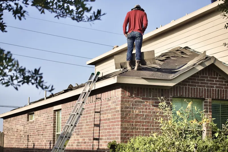 Professional roofer working on a residential roof in Pine Swamp